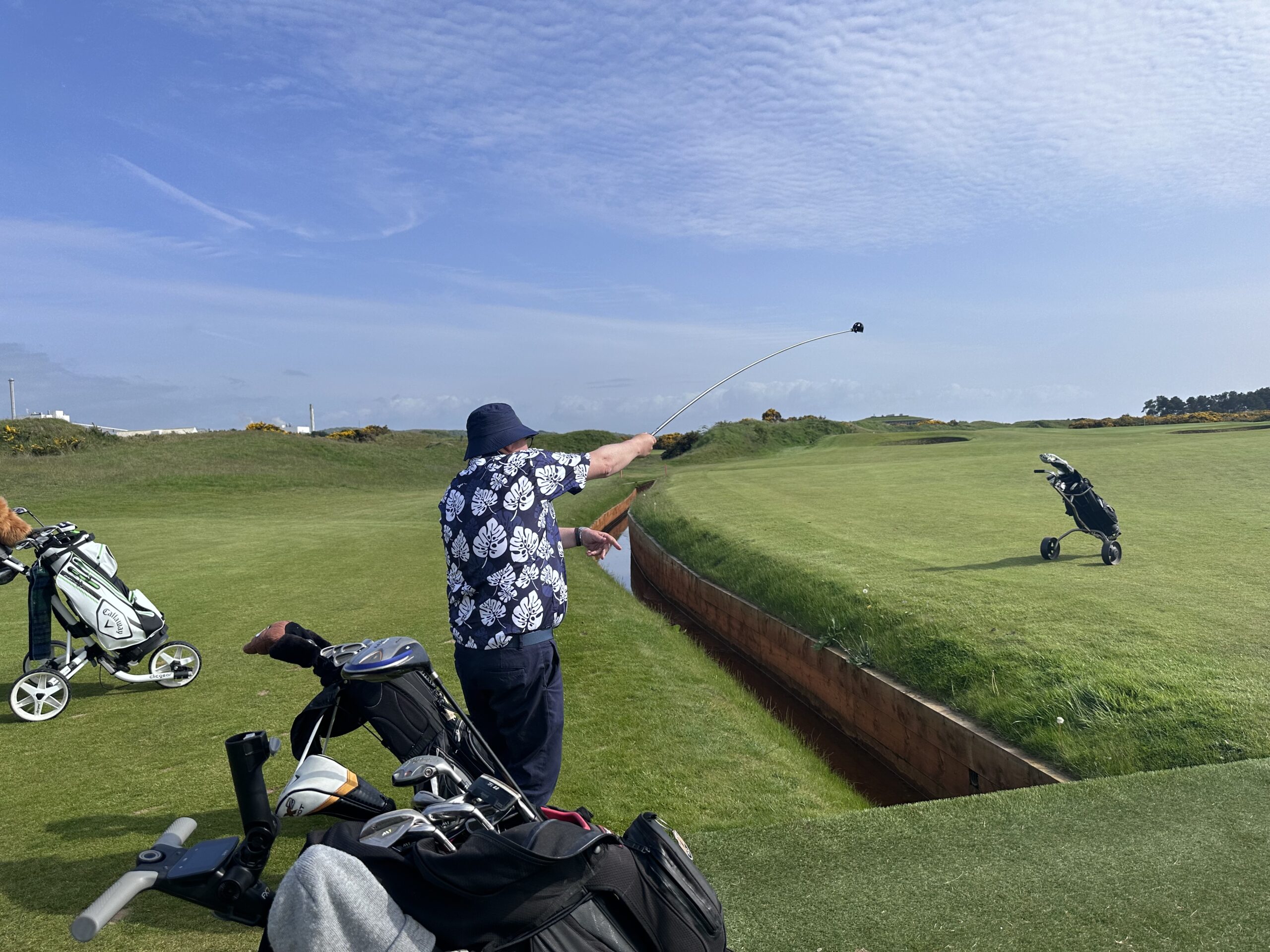 Brian demonstrates his unusual golf swing for his teammates