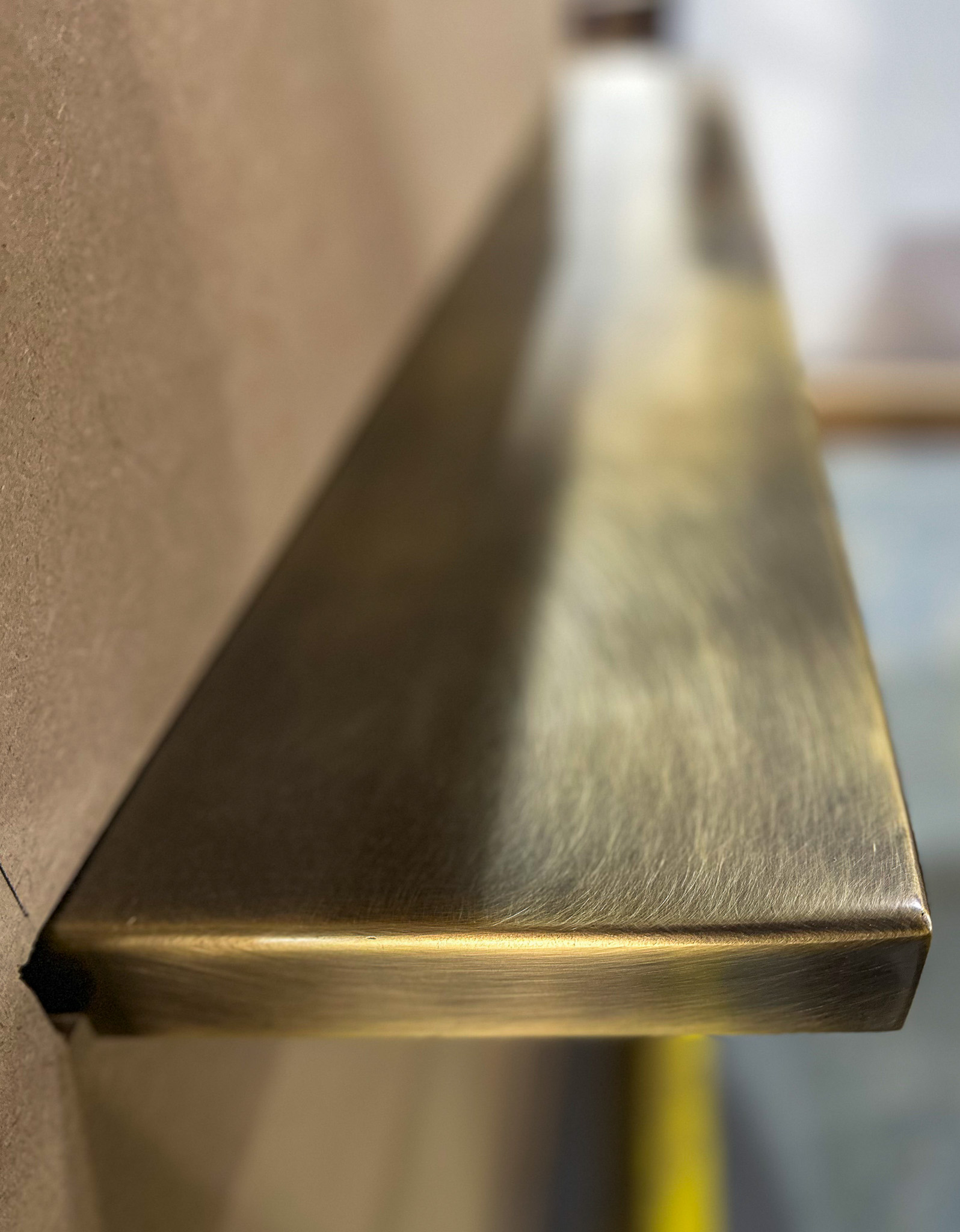 a close-up of the brass patina shelf on the reception pod